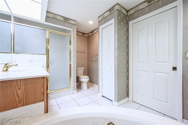full bathroom featuring tile patterned flooring, wallpapered walls, a shower stall, toilet, and vanity