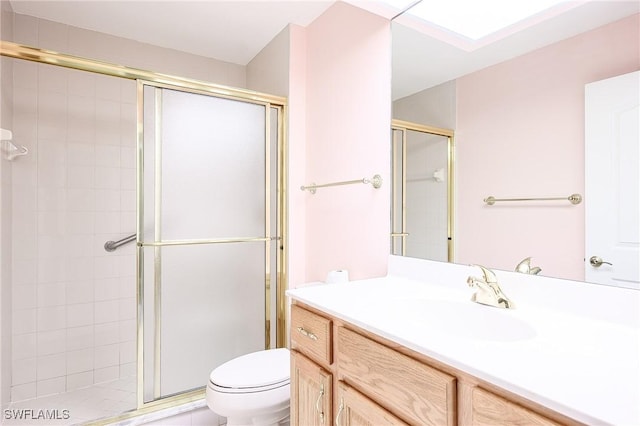 full bathroom with a stall shower, toilet, and vanity