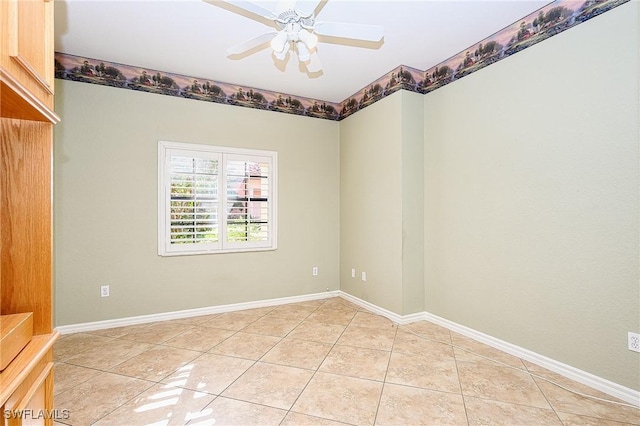 spare room with ceiling fan, light tile patterned floors, and baseboards
