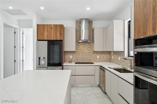 kitchen featuring stainless steel appliances, a sink, marble finish floor, wall chimney exhaust hood, and modern cabinets