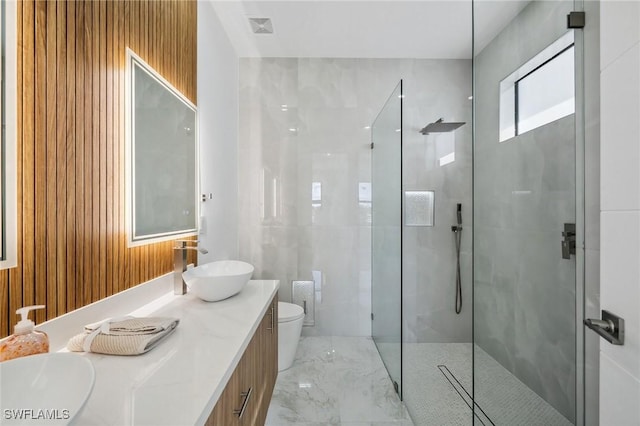 full bath featuring visible vents, toilet, marble finish floor, a walk in shower, and a sink