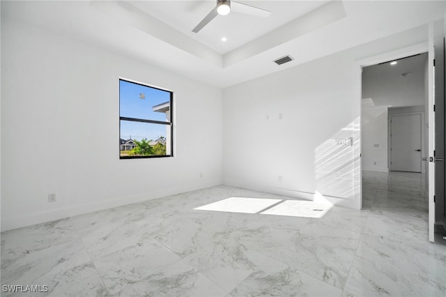 unfurnished room featuring baseboards, visible vents, a raised ceiling, a ceiling fan, and recessed lighting