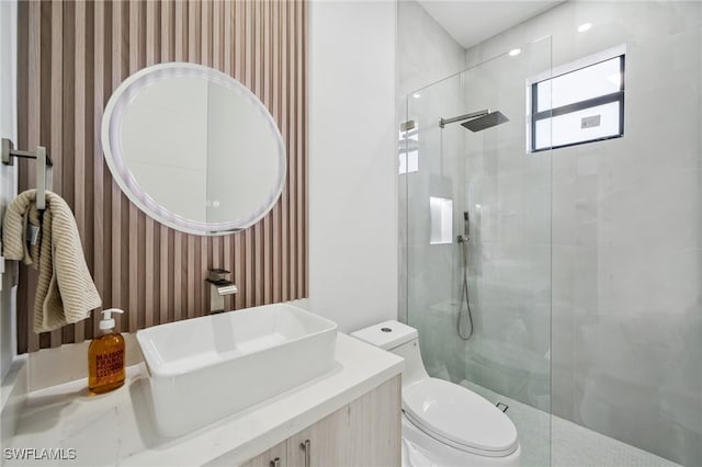 bathroom with a shower stall, toilet, and wallpapered walls