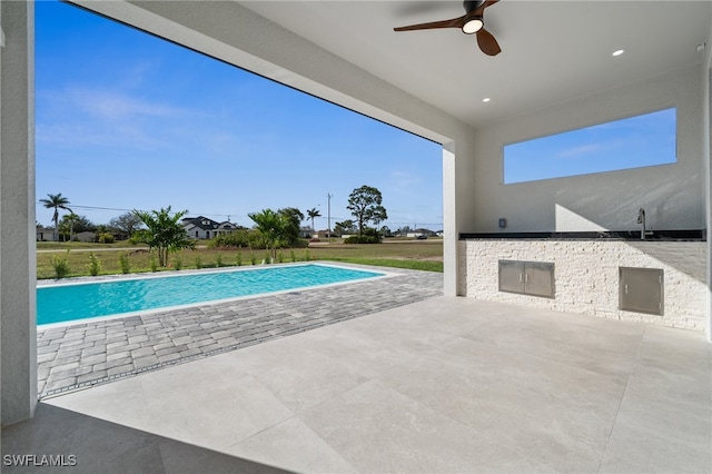 pool featuring a ceiling fan and a patio area