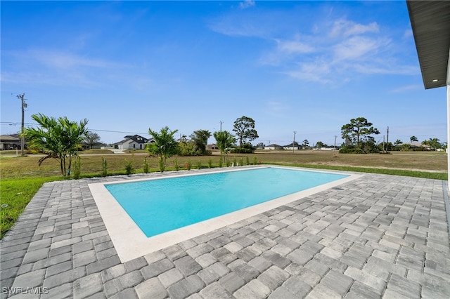 outdoor pool featuring a patio and a yard