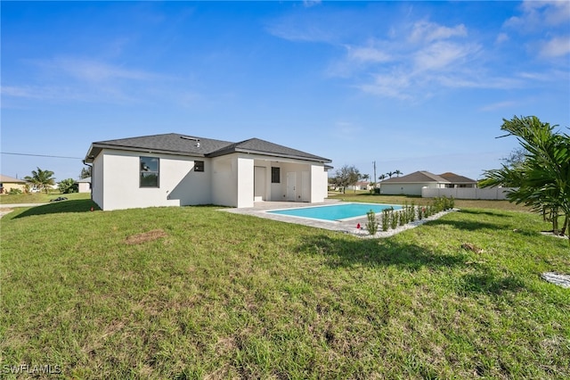 back of house featuring stucco siding, a patio, a fenced in pool, and a yard