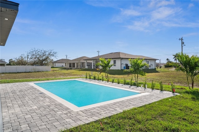 view of pool featuring a patio area, a fenced in pool, and a lawn