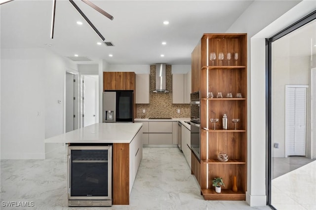 kitchen featuring wall chimney range hood, modern cabinets, wine cooler, and stainless steel appliances