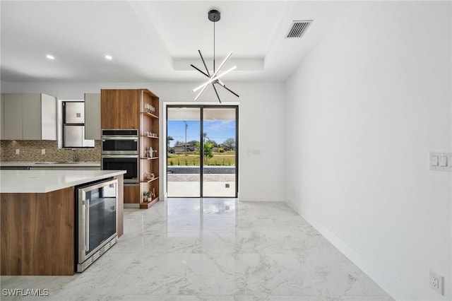 kitchen featuring a tray ceiling, open shelves, visible vents, stainless steel double oven, and beverage cooler