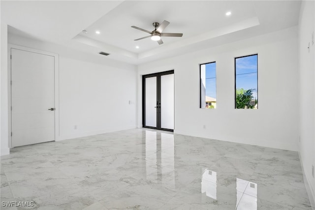 unfurnished room with recessed lighting, visible vents, marble finish floor, french doors, and a tray ceiling