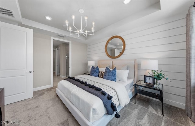 bedroom featuring carpet floors, a raised ceiling, visible vents, and a notable chandelier