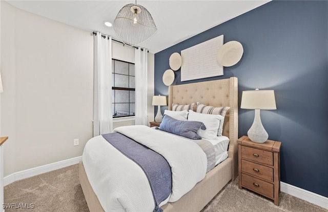 bedroom featuring carpet and baseboards