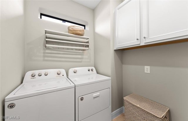 laundry room with cabinet space and washer and clothes dryer