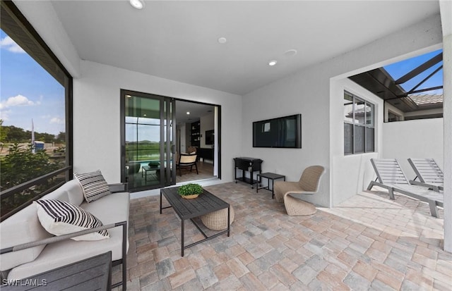 view of patio featuring a lanai