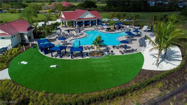 pool with a yard, fence, and a patio