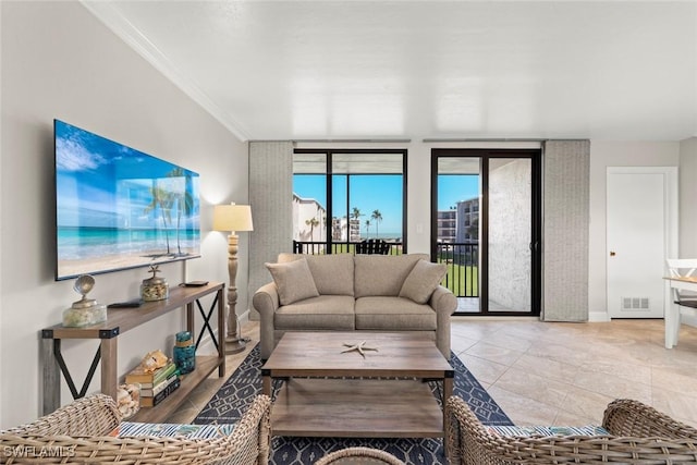 living room featuring crown molding and visible vents