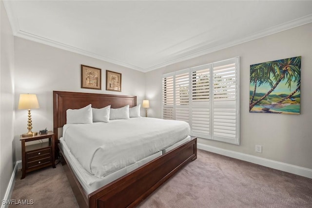 carpeted bedroom featuring baseboards and ornamental molding