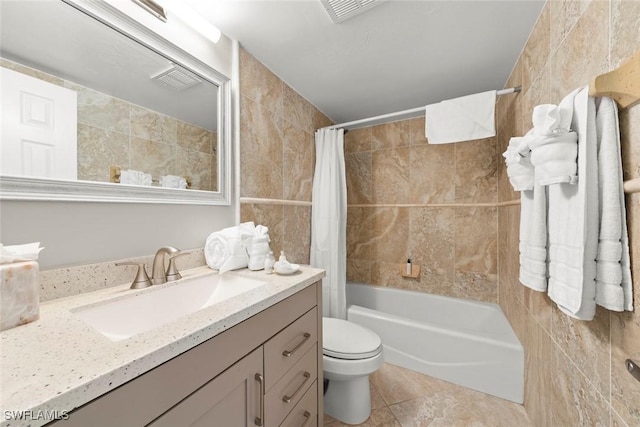 full bath with vanity, shower / bathtub combination with curtain, tile patterned flooring, tile walls, and toilet