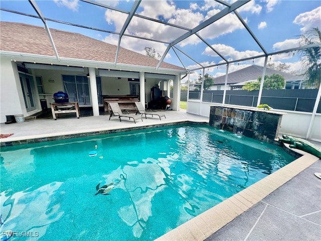 view of pool with a patio, a lanai, a fenced in pool, and fence