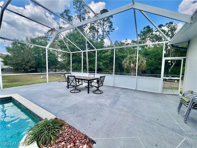 view of patio featuring glass enclosure and an outdoor pool