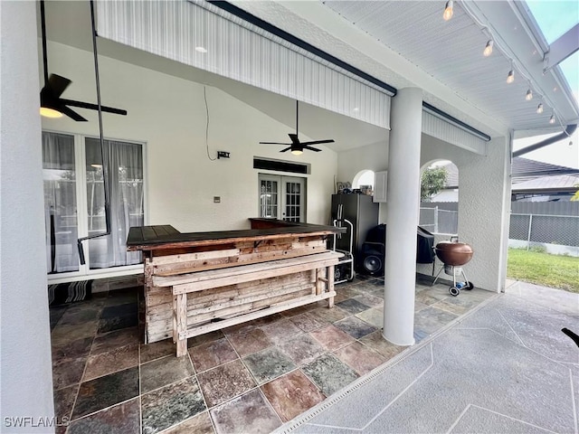 view of patio / terrace featuring fence, a ceiling fan, and french doors