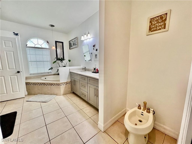 bathroom with vanity, baseboards, a bath, tile patterned floors, and a bidet