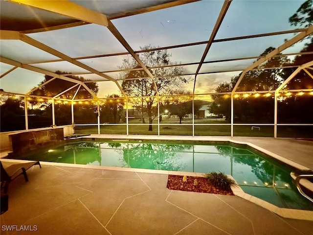 outdoor pool with a lanai and a patio area