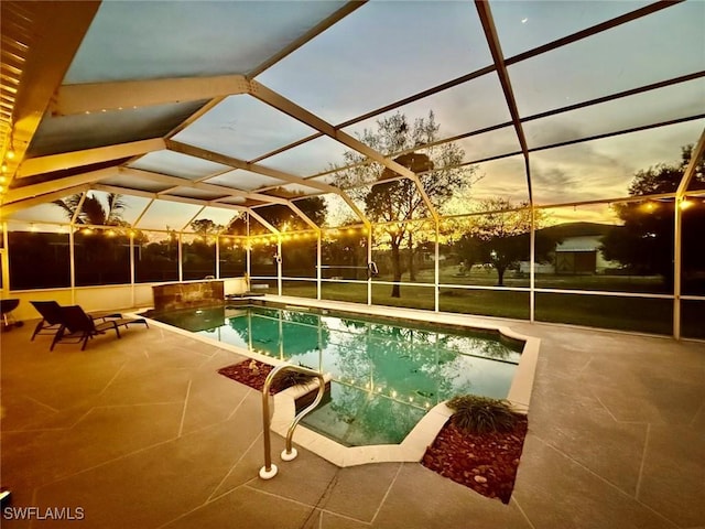 pool at dusk featuring a patio area, a lanai, and an outdoor pool