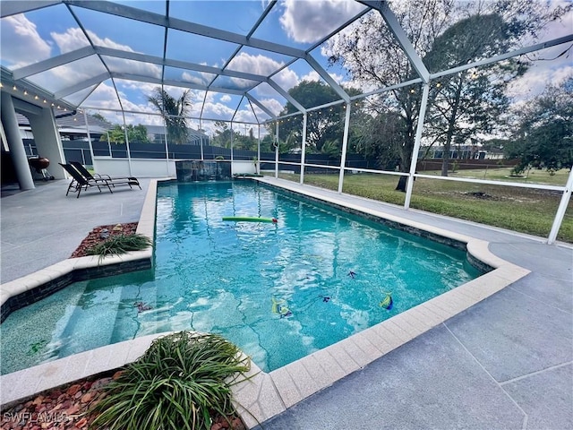 outdoor pool featuring a lanai, a patio area, and a lawn