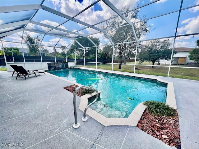 pool with a patio and glass enclosure