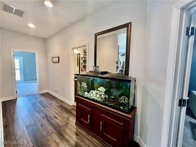 hall with dark wood-style floors, recessed lighting, visible vents, and baseboards