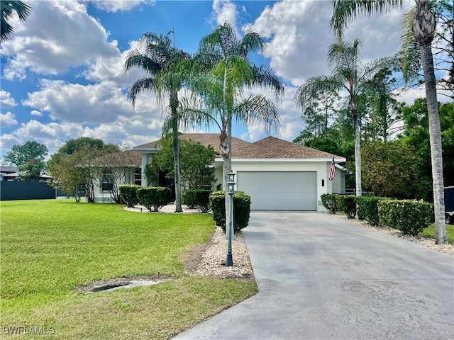 single story home featuring an attached garage, driveway, a front lawn, and stucco siding