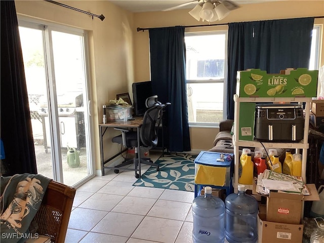 office area featuring baseboards, ceiling fan, and tile patterned floors