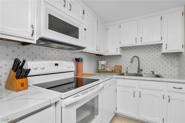 kitchen featuring white appliances, white cabinetry, and a sink