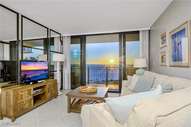 tiled living room featuring expansive windows