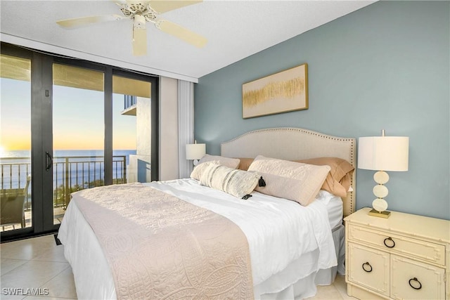 bedroom with access to outside, floor to ceiling windows, a ceiling fan, and light tile patterned flooring