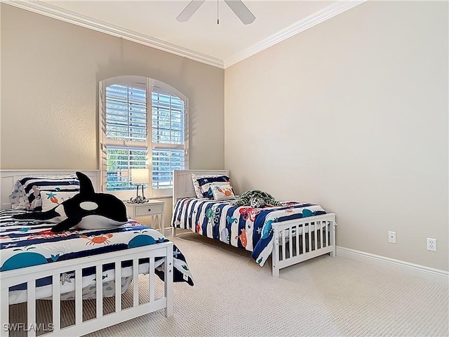 carpeted bedroom featuring baseboards, ornamental molding, and a ceiling fan