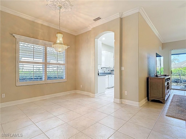 spare room with arched walkways, visible vents, crown molding, and light tile patterned floors