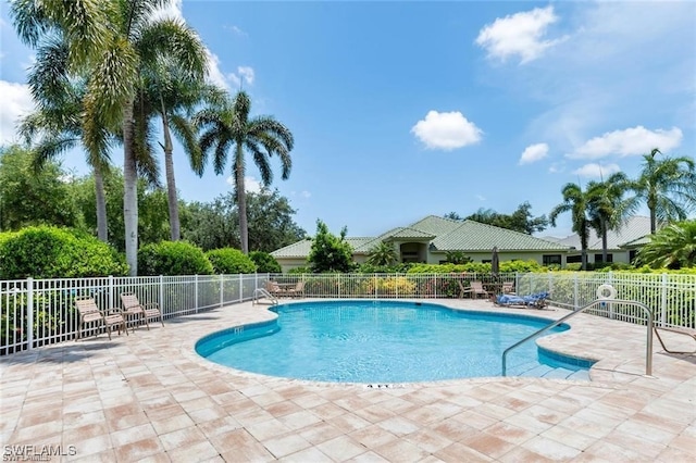 pool featuring a patio and fence