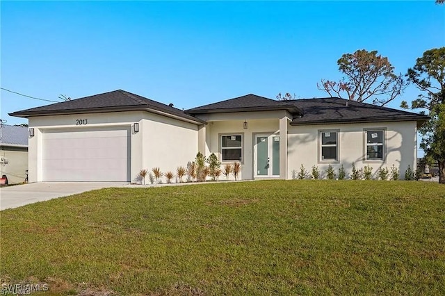 prairie-style house with an attached garage, stucco siding, driveway, and a front yard