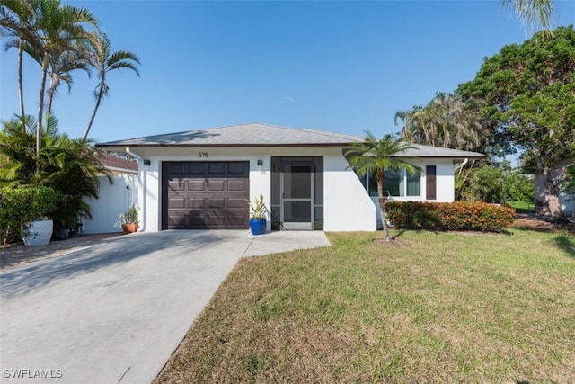 ranch-style home with stucco siding, a front yard, concrete driveway, and an attached garage