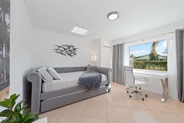 bedroom featuring tile patterned flooring and baseboards