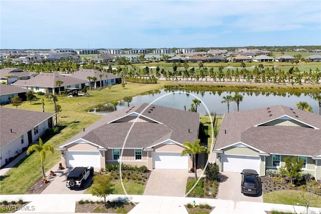 drone / aerial view with a water view and a residential view