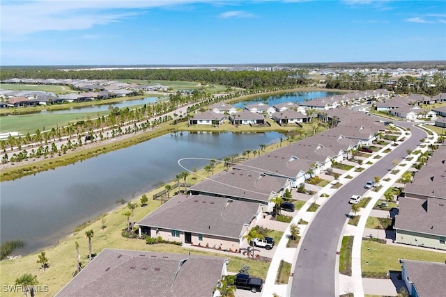 drone / aerial view featuring a water view and a residential view