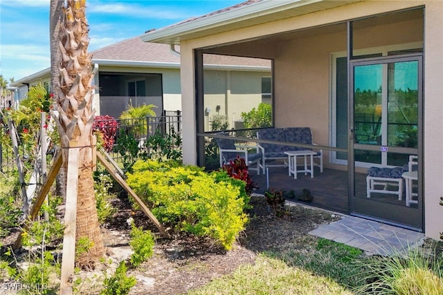 doorway to property featuring stucco siding