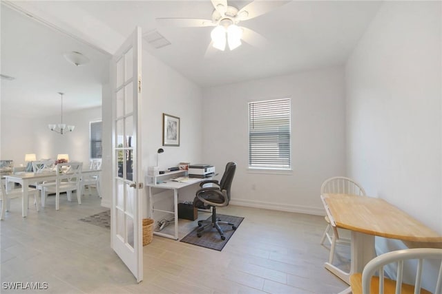 office space featuring ceiling fan with notable chandelier, visible vents, baseboards, and french doors