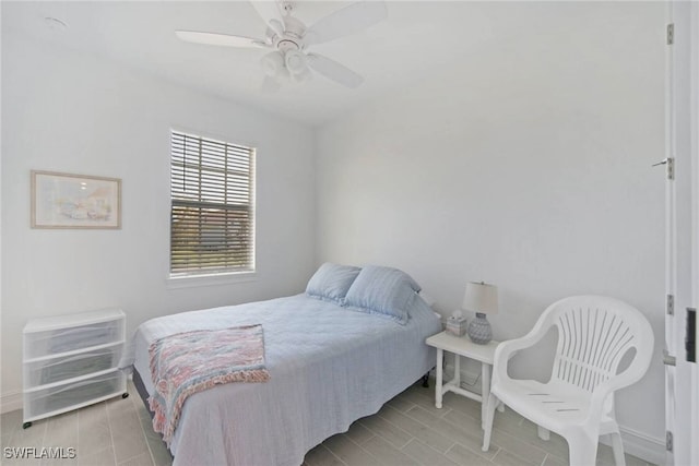 bedroom featuring baseboards, a ceiling fan, and wood tiled floor