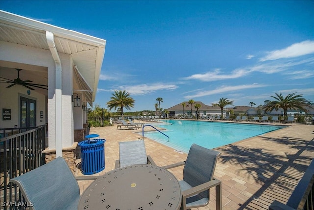 community pool featuring ceiling fan, outdoor dining space, a patio area, and fence