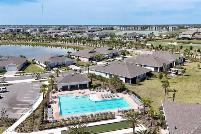 birds eye view of property with a water view and a residential view