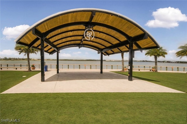 surrounding community with a water view, a gazebo, and a yard